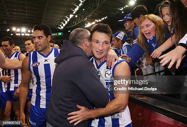 Brent Harvey of the Kangaroos is hugged by his father Neil Harvey after his 350th game during the round ten AFL match between the North Melbourne...