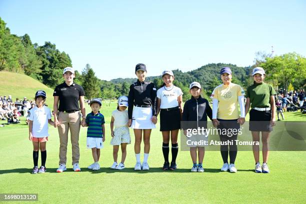 Akie Iwai, Yuka Yasuda and Mao Saigo of Japan pose with escort kids on the 1st tee during the final round of 50th Miyagi TV Cup Dunlop Ladies Open...