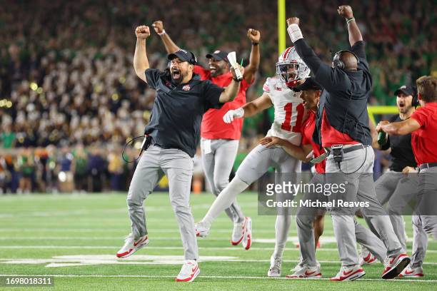 Head coach Ryan Day of the Ohio State Buckeyes celebrates a rushing touchdown by Chip Trayanum during the fourth quarter against the Notre Dame...