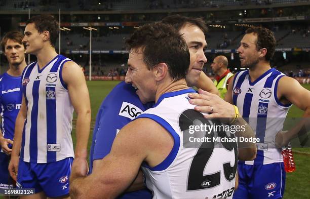Brent Harvey of the Kangaroos is hugged by coach Brad Scott after his 350th game during the round ten AFL match between the North Melbourne Kangaroos...