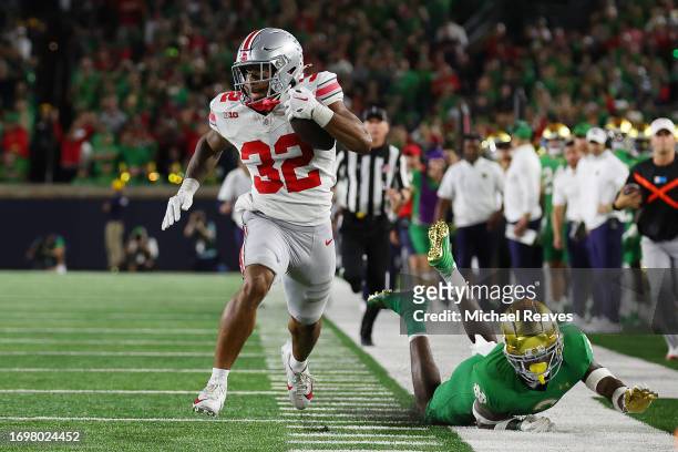 TreVeyon Henderson of the Ohio State Buckeyes runs for a touchdown during the third quarter against the Notre Dame Fighting Irish at Notre Dame...