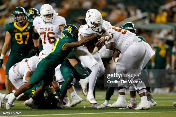 Jonathon Brooks of the Texas Longhorns runs through the tackle by Caden Jenkins of the Baylor Bears in the fourth quarter at McLane Stadium on...