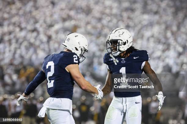 Liam Clifford and KeAndre Lambert-Smith of the Penn State Nittany Lions celebrate after an offensive touchdown against the Iowa Hawkeyes during the...