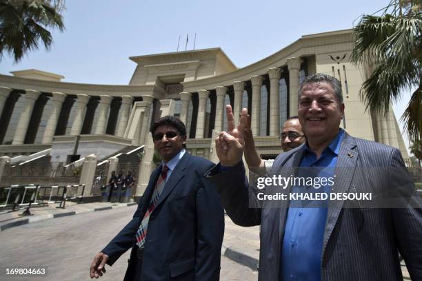 Egyptian former parliament member Hamdi el-Fakharany flashes the victory sign as he leaves the constitutional court in Cairo on June 2, 2013. Egypt's...