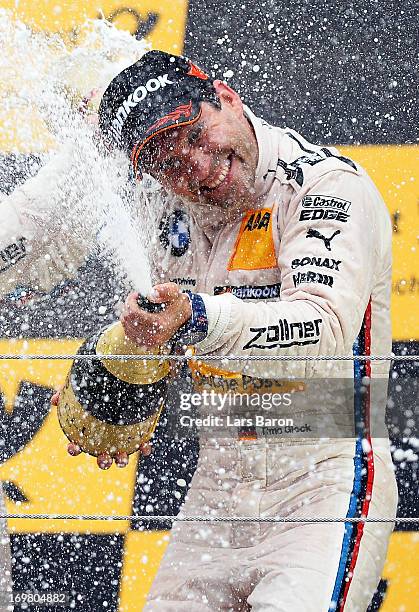 Third placed Timo Glock of Germany and BMW Team MTEK celebrates after the third round of the DTM 2013 German Touring Car Championship at Red Bull...