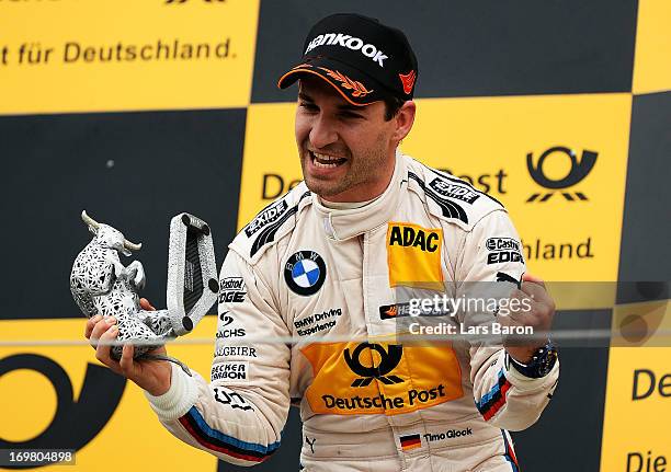 Third placed Timo Glock of Germany and BMW Team MTEK celebrates after the third round of the DTM 2013 German Touring Car Championship at Red Bull...