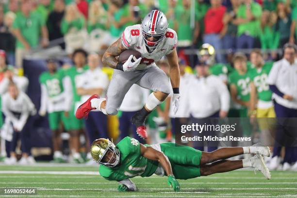 Cade Stover of the Ohio State Buckeyes leaps over Ramon Henderson of the Notre Dame Fighting Irish during the third quarter at Notre Dame Stadium on...