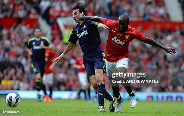 Manchester United legend Dwight Yorke vies with Real Madrid legend Jose Amavisca during a Charity football match between Manchester United legends...