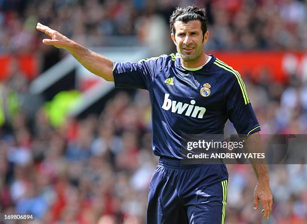 Real Madrid legend Luis Figo gestures during a Charity football match between Manchester United Legends and Real Madrid Legends at Old Trafford in...