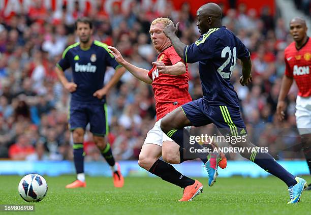 Real Madrid legend Claude Makelele vies with Manchester United legend Paul Scholes during a Charity football match between Manchester United legends...