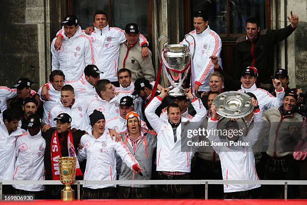 The team of Bayern Muenchen celebrate winning Bundesliga, Champions League and DFB Cup on the town hall balcony at Marienplatz on June 2, 2013 in...