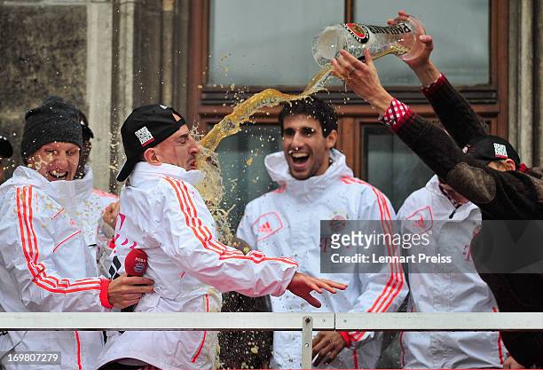 Franck Ribery of FC Bayern Muenchen has beer poured over him by his team-mate Anatoliy Tymoshchuk as they celebrate winning the Bundesliga, Champions...