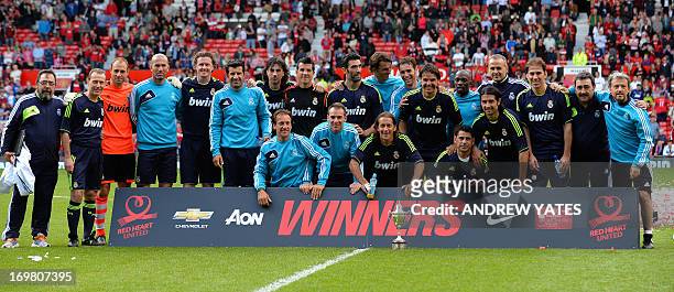 Real Madrid Legends pose after winning a Charity football match between Manchester United Legends and Real Madrid Legends at Old Trafford in...