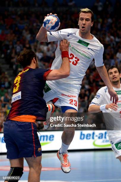 Pascal Hens of Hamburg is tackled by Jesper Noddesbo of Barcelona during the EHF Final Four final match between FC Barcelona Intersport and HSV...