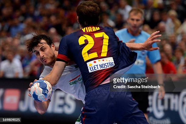 Domagoj Duvnjak of Hamburg vies with Viran Morros de Argila of Barcelona during the EHF Final Four final match between FC Barcelona Intersport and...