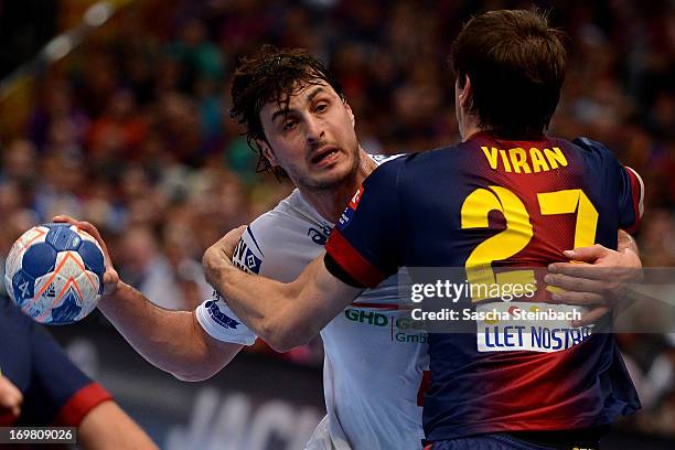 Domagoj Duvnjak of Hamburg vies with Viran Morros de Argila of Barcelona during the EHF Final Four final match between FC Barcelona Intersport and...