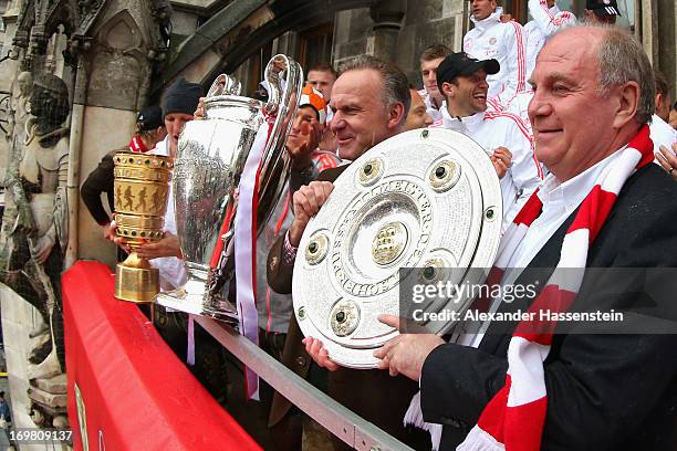Uli Hoeness , President of FC Bayern Muenchen celebrate winning Bundesliga trophy, Karl-Heinz Rummenigge with Champions League winners trophy and...