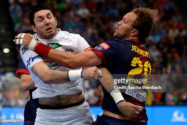 Blazenko Lackovic of Hamburg clashes with Magnus Jernemyr of Barcelona during the EHF Final Four final match between FC Barcelona Intersport and HSV...