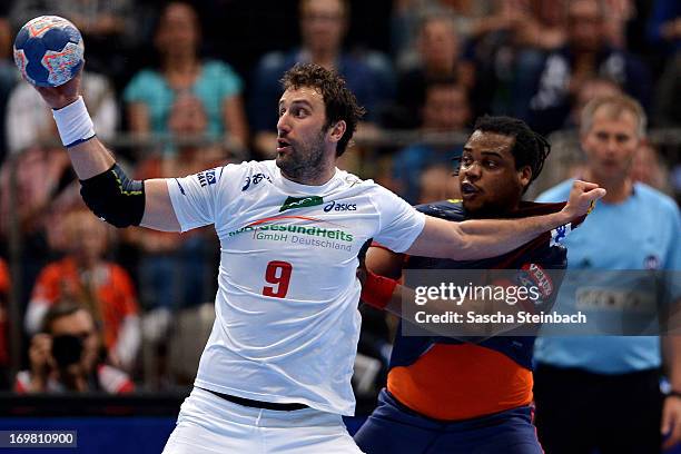 Igor Vori of Hamburg vies with Cedric Sorhaindo of Barcelona during the EHF Final Four final match between FC Barcelona Intersport and HSV Hamburg at...