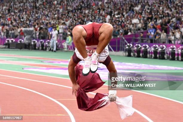 Silver medallist Qatar's Ashraf El-Seify celebrates after the men's hammer throw final athletics event during the 2022 Asian Games in Hangzhou in...