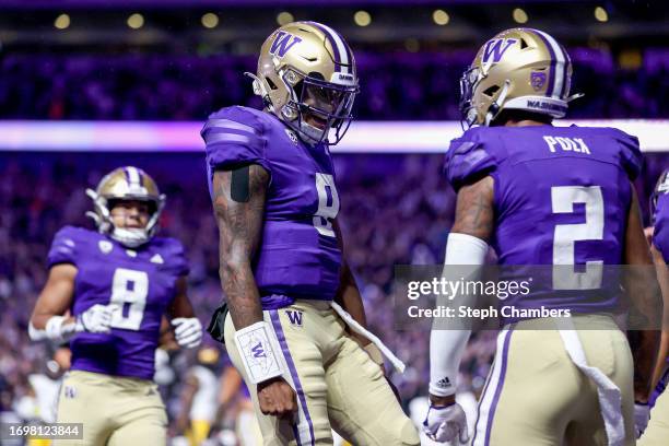 Michael Penix Jr. #9 and Ja'Lynn Polk of the Washington Huskies celebrate their touchdown during the first quarter against the California Golden...