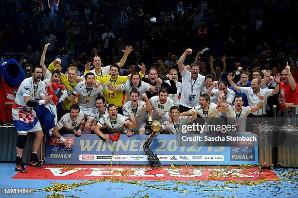 The team of Hamburg celebrate winning the championship with the trophy after the EHF Final Four final match between FC Barcelona Intersport and HSV...