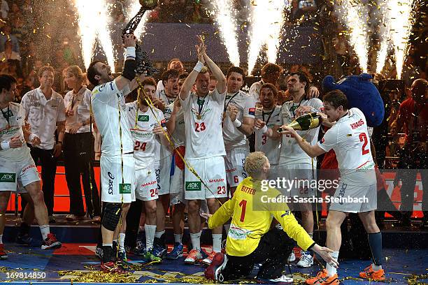 The team of Hamburg celebrate winning the championship with the trophy after the EHF Final Four final match between FC Barcelona Intersport and HSV...