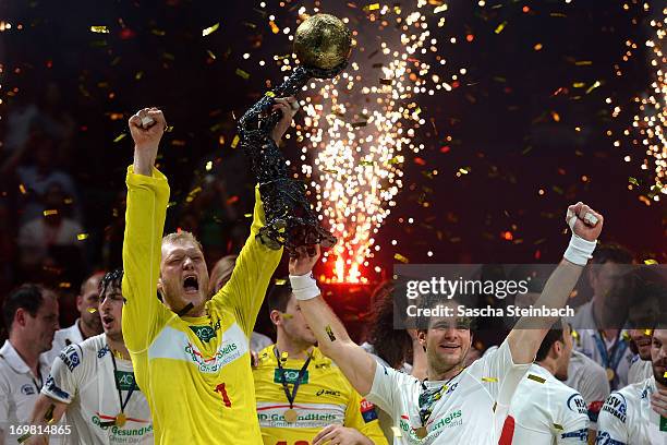 Goalkeeper Johannes Bitter and Matthias Flohr of Hamburg celebrate the championship with the trophy after the EHF Final Four final match between FC...