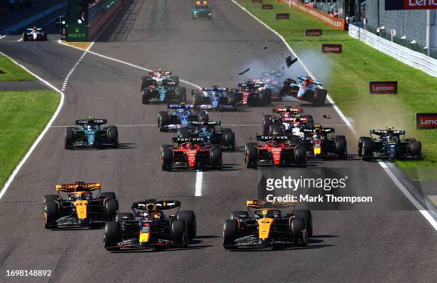 Max Verstappen of the Netherlands driving the Oracle Red Bull Racing RB19 leads Lando Norris of Great Britain driving the McLaren MCL60 Mercedes and...
