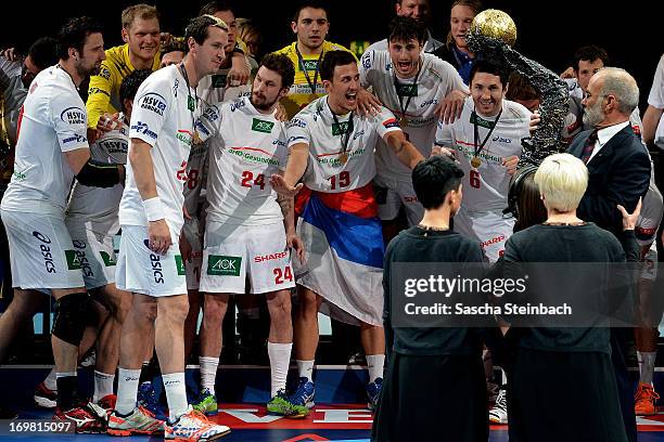 The team of Hamburg celebrates the championship while getting the trophy after the EHF Final Four final match between FC Barcelona Intersport and HSV...