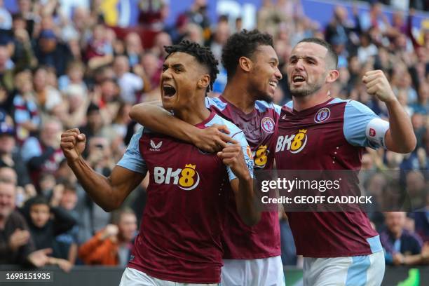 Aston Villa's English striker Ollie Watkins celebrates scoring his team's fourth goal with teammate Aston Villa's French midfielder Boubacar Kamara...