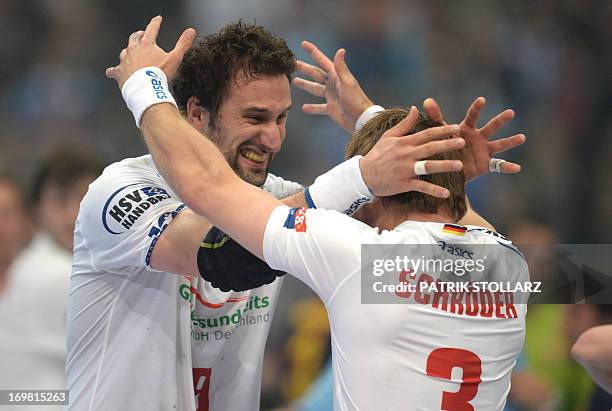 Hamburg´s Stefan Schroeder and Hamburg´s Croatian player Igor Vori celebrate after winning the EHF Final Four Handball Champions League Final match...