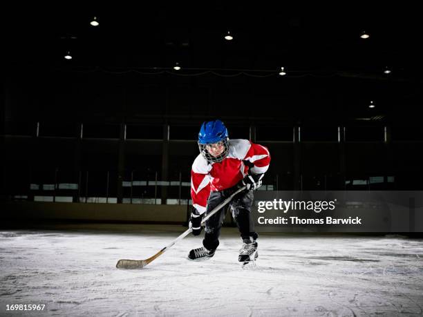 young male ice hockey player on ice - ice hockey player bildbanksfoton och bilder