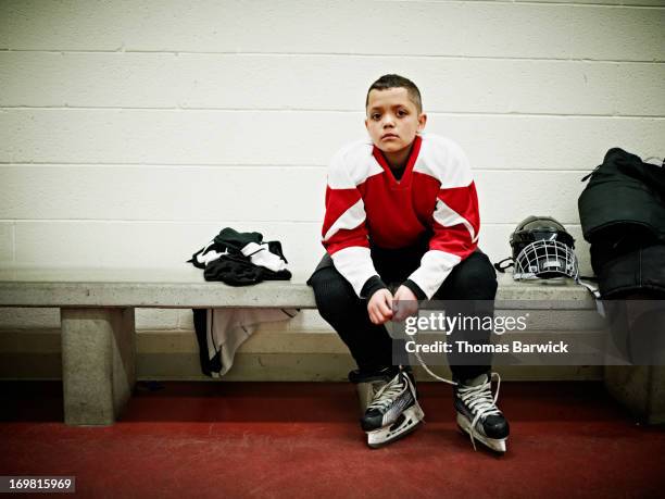 young hockey player in locker room before game - girls ice hockey stock pictures, royalty-free photos & images