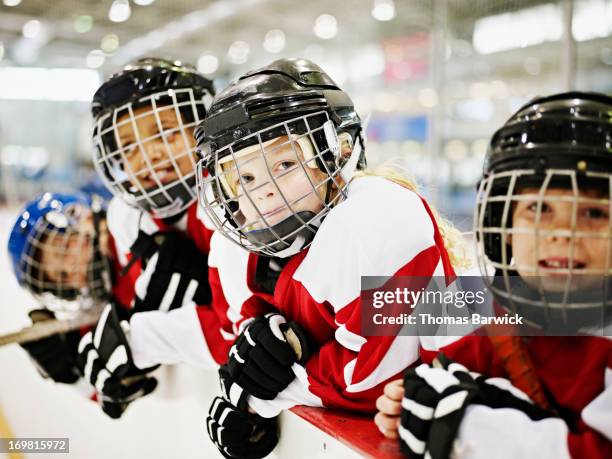 young smiling ice hockey players in players box - ice hockey day 8 imagens e fotografias de stock