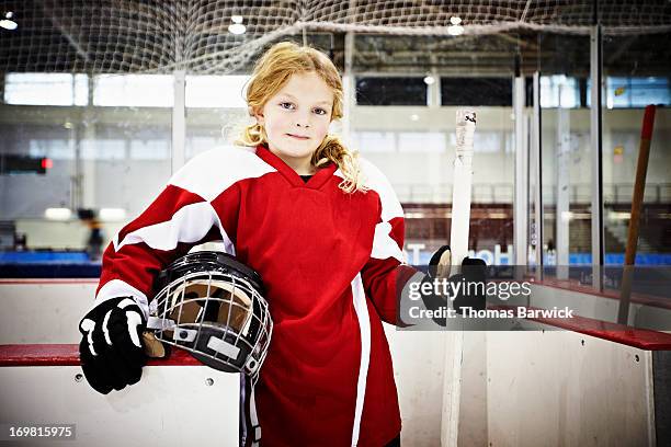 young female ice hockey player in players box - hockey kids stock-fotos und bilder