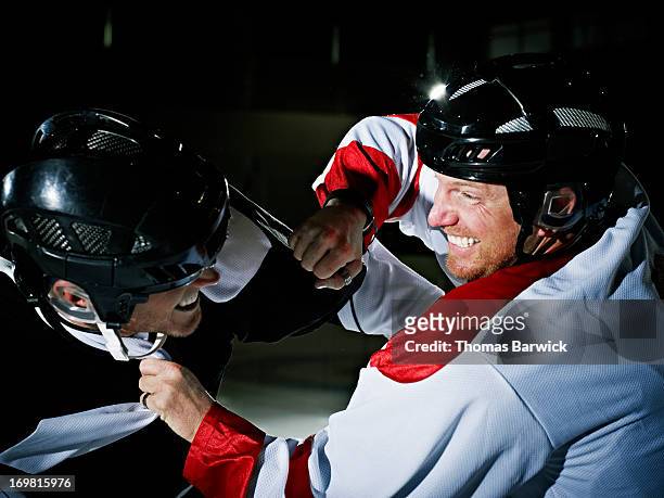 two ice hockey players fighting - intimidation stock pictures, royalty-free photos & images