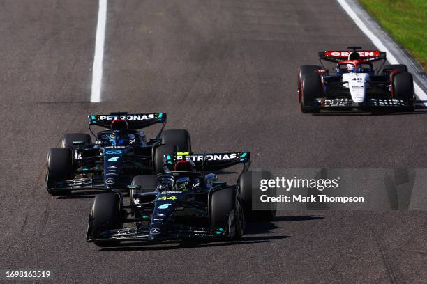 Lewis Hamilton of Great Britain driving the Mercedes AMG Petronas F1 Team W14 leads George Russell of Great Britain driving the Mercedes AMG Petronas...