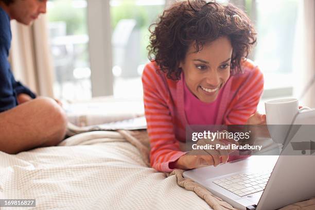 couple relaxing on bed - read and newspaper and bed stock pictures, royalty-free photos & images