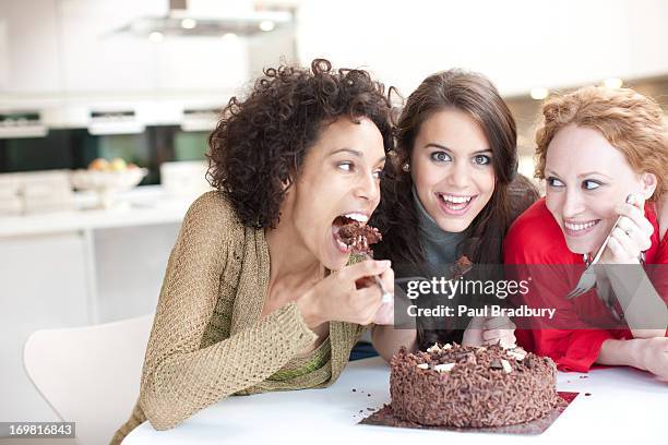 friends eating chocolate cake - sharing chocolate stock pictures, royalty-free photos & images