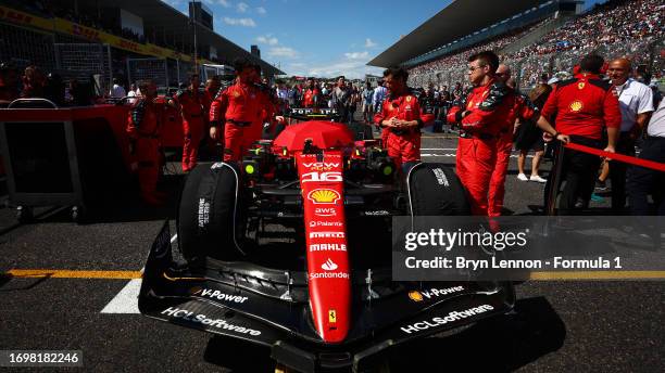 The car of Charles Leclerc of Monaco and Ferrari is prepared on the grid prior to the F1 Grand Prix of Japan at Suzuka International Racing Course on...