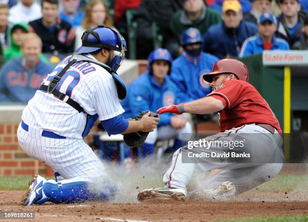 Dioner Navarro of the Chicago Cubs tags out Jason Kubel of the Arizona Diamondbacks during the third inning on June 2, 2013 at Wrigley Field in...