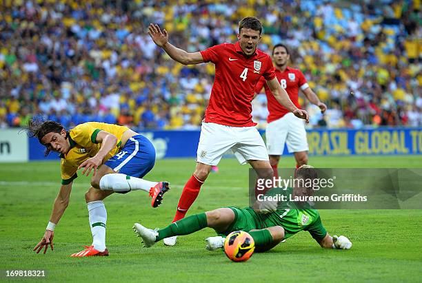 Joe Hart of England saves at the feet of Filipe Luis during the International Friendly match between England and Brazil at Maracana on June 2, 2013...