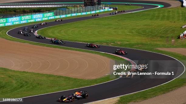 Max Verstappen of the Netherlands driving the Oracle Red Bull Racing RB19 leads Lando Norris of Great Britain driving the McLaren MCL60 Mercedes and...