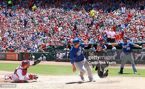 George Kottaras looks on as Geovany Soto of the Texas Rangers shows umpire Bill Miller the ball after tagging out Billy Butler of the Kansas City...