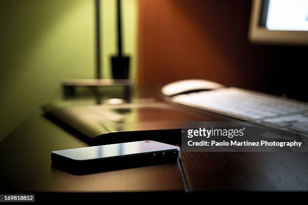 smartphone on black desktop - smart phone on table stock pictures, royalty-free photos & images