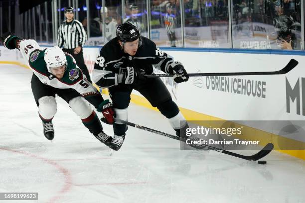 Sean Durzi of the Arizona Coyotes competes with Jaret Anderson-Dolan of the LA Kings during the NHL Global Series match between Arizona Coyotes and...