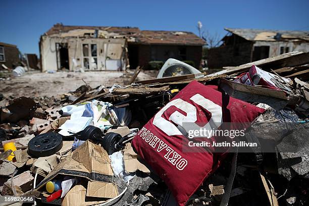 University of Oklahoma pillow sits on a pile of debris outside of a home damaged by a tornado on June 2, 2013 in Moore, Oklahoma. Residents of Moore,...