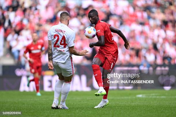 Stuttgart's Guinean forward Serhou Guirassy and Cologne's German defender Jeff Chabot vie for the ball during the German first division Bundesliga...