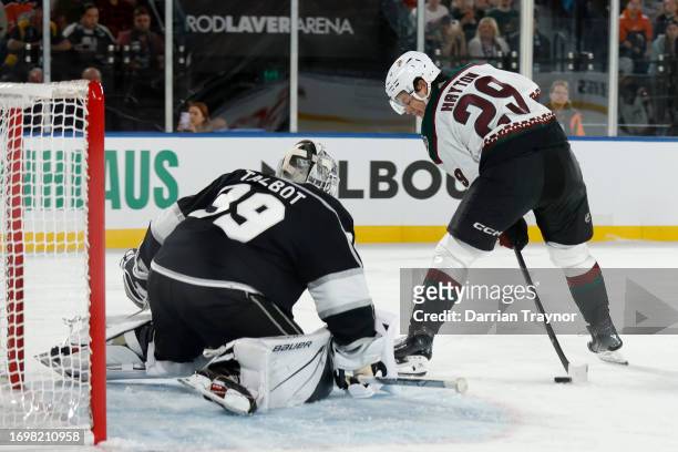 Barrett Hayton of the Arizona Coyotes takes shot through his legs during the NHL Global Series match between Arizona Coyotes and Los Angeles Kings at...